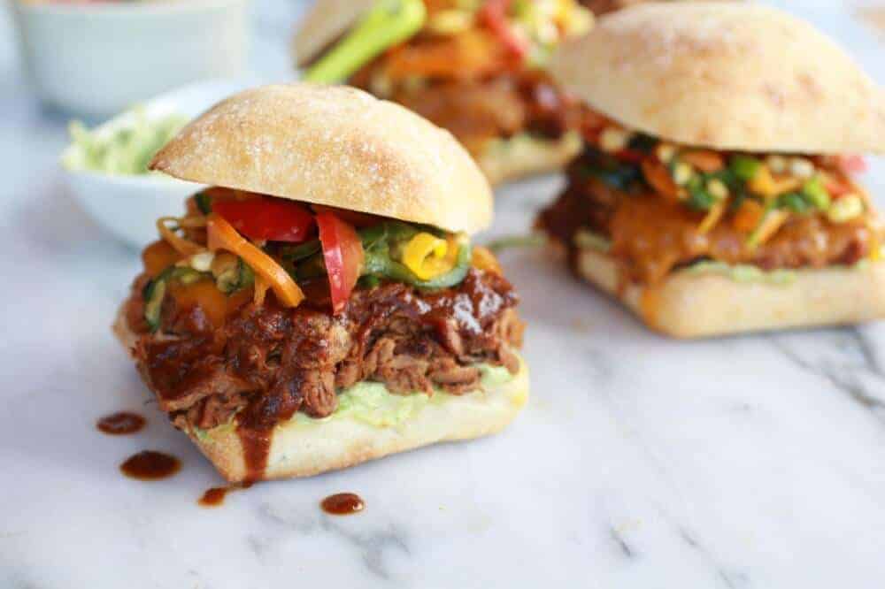 Cheesy Crockpot Cajun Pulled Pork with Southwest Pepper-Corn Slaw | halfbakedharvest.com