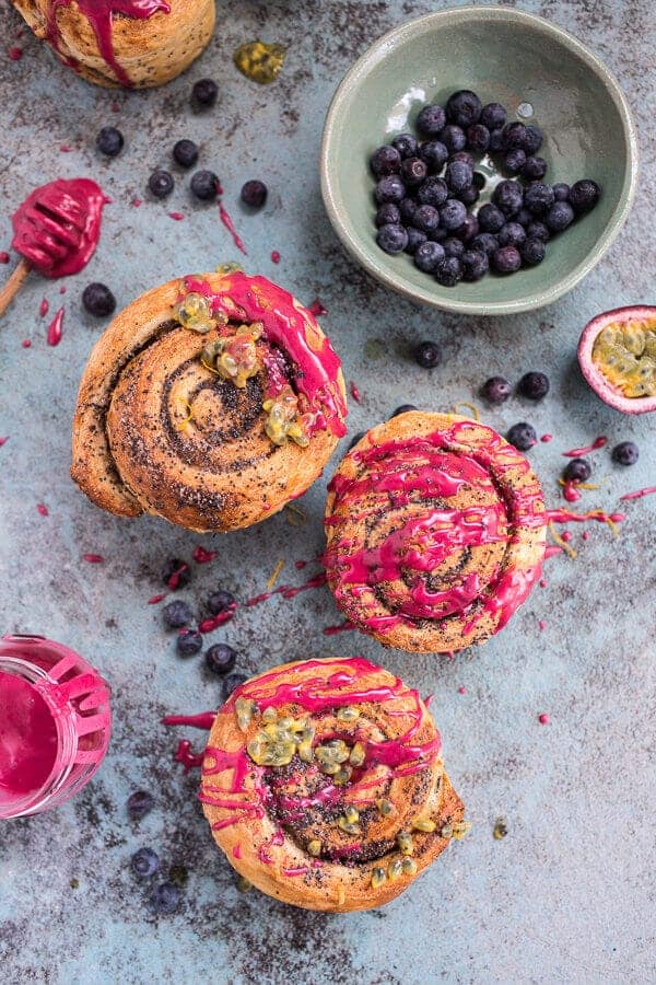 Meyer Lemon Poppy Seed Morning Buns with Blueberry Passionfruit Glaze | halfbakedharvest.com @hbharvest