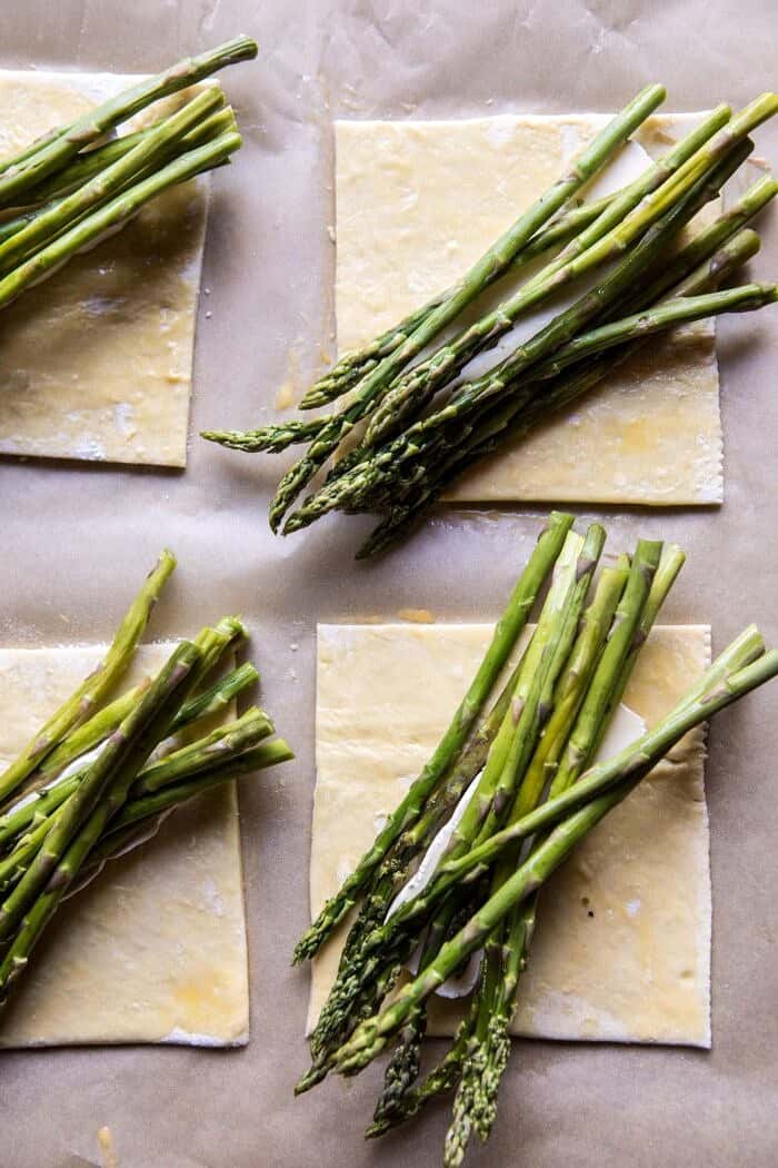 Asparagus and Brie Puff Pastry with Thyme Honey | halfbakedharvest.com #brunch #spring #recipe overhead prep photo of pasty with brie and asparagus