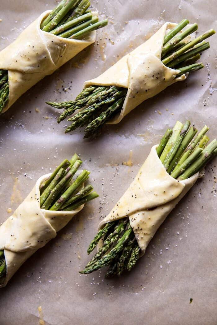 Asparagus and Brie Puff Pastry with Thyme Honey | halfbakedharvest.com #brunch #spring #recipe overhead prep photo of asparagus and brie pastry wrapped up and brushed with egg