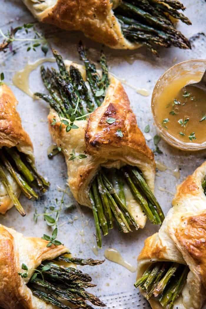 Asparagus and Brie Puff Pastry with Thyme Honey | halfbakedharvest.com #brunch #spring #recipe overhead close up photo of Asparagus and Brie Puff Pastry with Thyme Honey