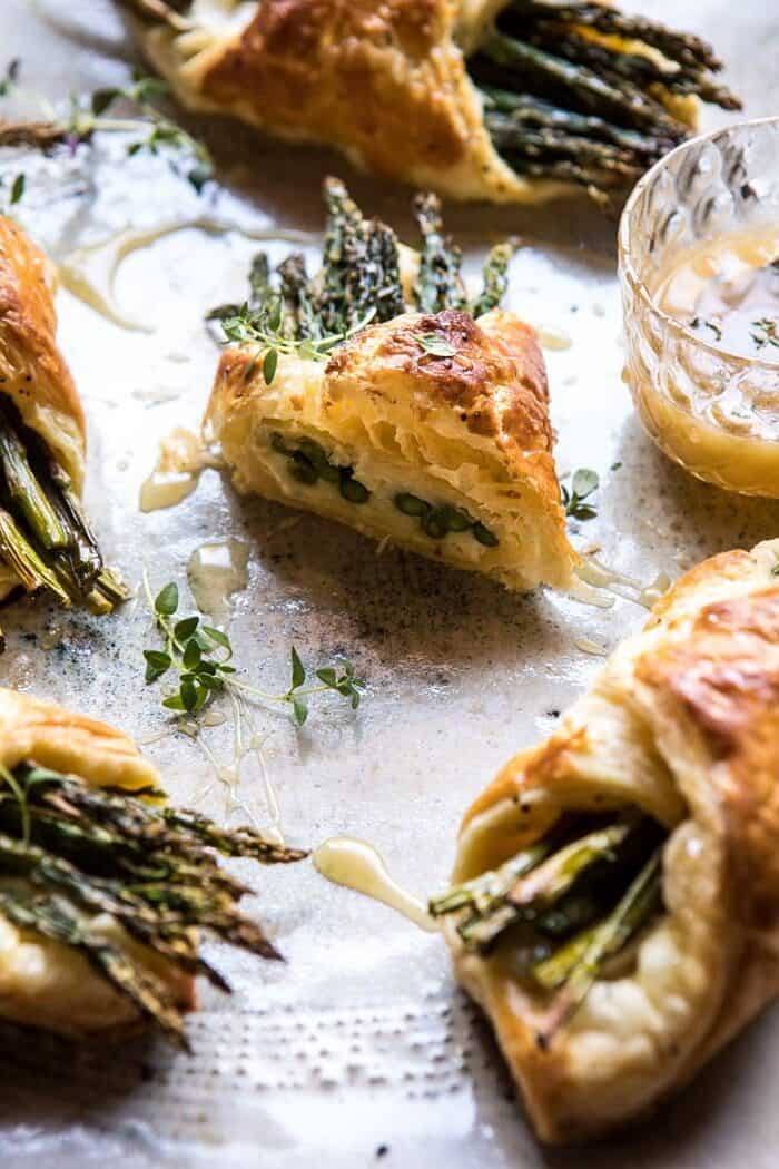 Asparagus and Brie Puff Pastry with Thyme Honey | halfbakedharvest.com #brunch #spring #recipe side photo of cut into Asparagus and Brie Puff Pastry with Thyme Honey
