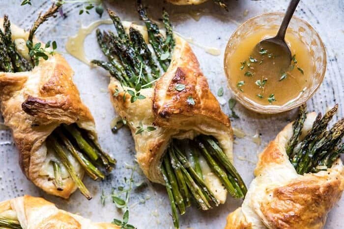 Asparagus and Brie Puff Pastry with Thyme Honey | halfbakedharvest.com #brunch #spring #recipe overhead horizontal photo of Asparagus and Brie Puff Pastry with Thyme Honey