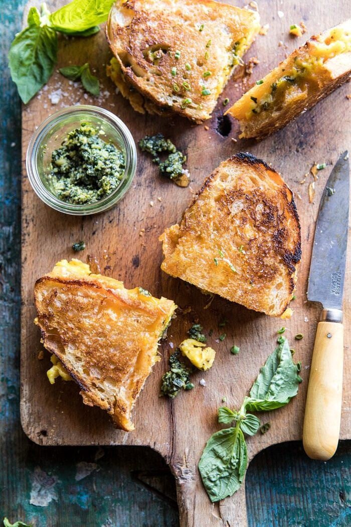 Breakfast Grilled Cheese with Soft Scrambled Eggs and Pesto | halfbakedharvest.com #breakfast #brunch #grilledcheese overhead photo of Breakfast Grilled Cheese with Soft Scrambled Eggs and Pesto