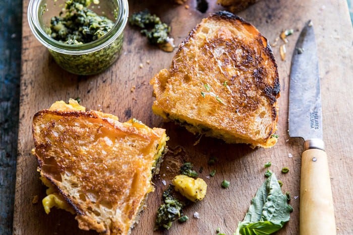 Breakfast Grilled Cheese with Soft Scrambled Eggs and Pesto | halfbakedharvest.com #breakfast #brunch #grilledcheese horizontal angled photo of Breakfast Grilled Cheese with Soft Scrambled Eggs and Pesto