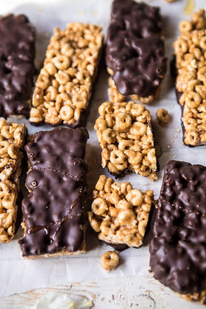 Chocolate Dipped Peanut Butter and Honey Cheerio Bars | halfbakedharvest.com #chocolate #dessert #easyrecipe side angle photo of Chocolate Dipped Peanut Butter and Honey Cheerio Bars with one bar broken