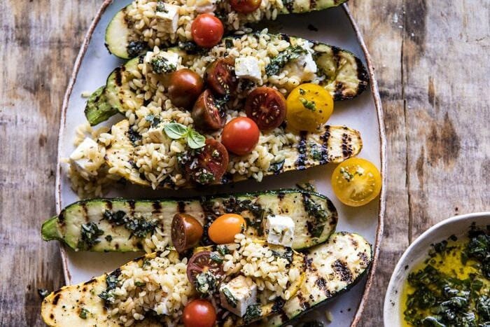 overhead horizontal photo Grilled Pesto Zucchini Stuffed with Tomatoes and Orzo
