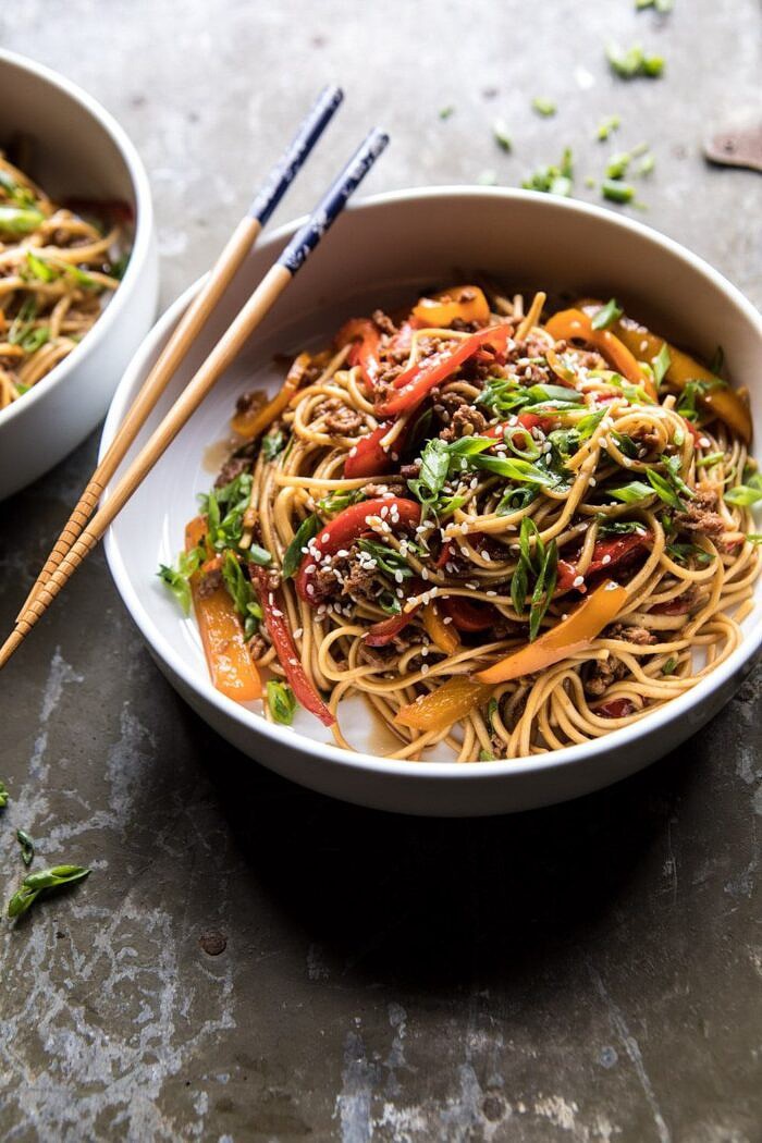 Weeknight 20 Minute Spicy Udon Noodles | halfbakedharvest.com #quick #easy #summerrecipe #healthy angled photo of Weeknight 20 Minute Spicy Udon Noodles with chopsticks