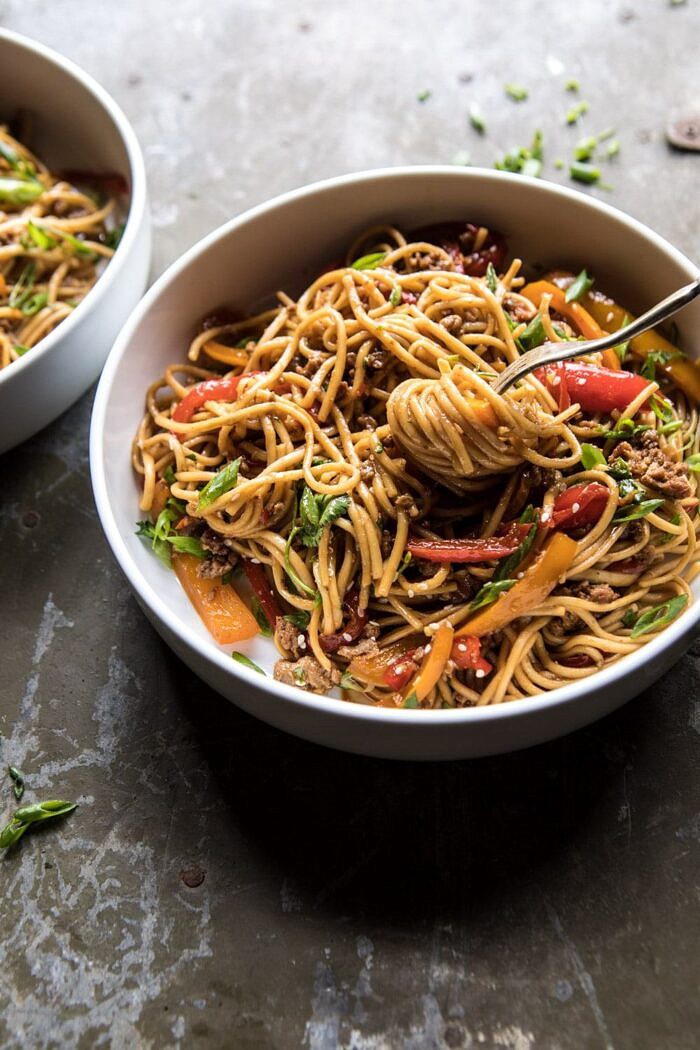 Weeknight 20 Minute Spicy Udon Noodles | halfbakedharvest.com #quick #easy #summerrecipe #healthy side angled photo of Weeknight 20 Minute Spicy Udon Noodles with fork