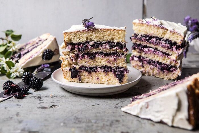 Blackberry Lavender Naked Cake with White Chocolate Buttercream | halfbakedharvest.com #summerrecipes #layercake #blueberries horizontal photo of Blackberry Lavender Naked Cake with White Chocolate Buttercream