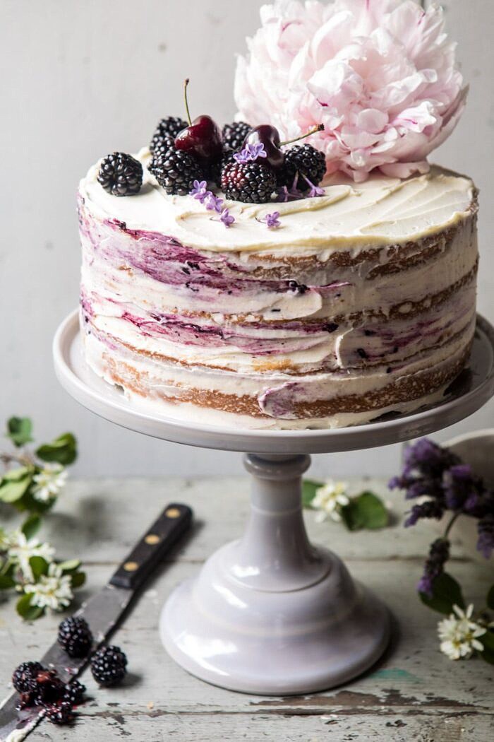 Blackberry Lavender Naked Cake with White Chocolate Buttercream | halfbakedharvest.com #summerrecipes #layercake #blueberries close up side angled photo of Blackberry Lavender Naked Cake with White Chocolate Buttercream