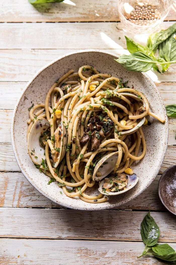 Buttery Mushroom and Clam Pasta | halfbakedharvest.com #pasta #easyrecipe #summerrecipes overhead photo off Buttery Mushroom and Clam Pasta with basil and flakey salt