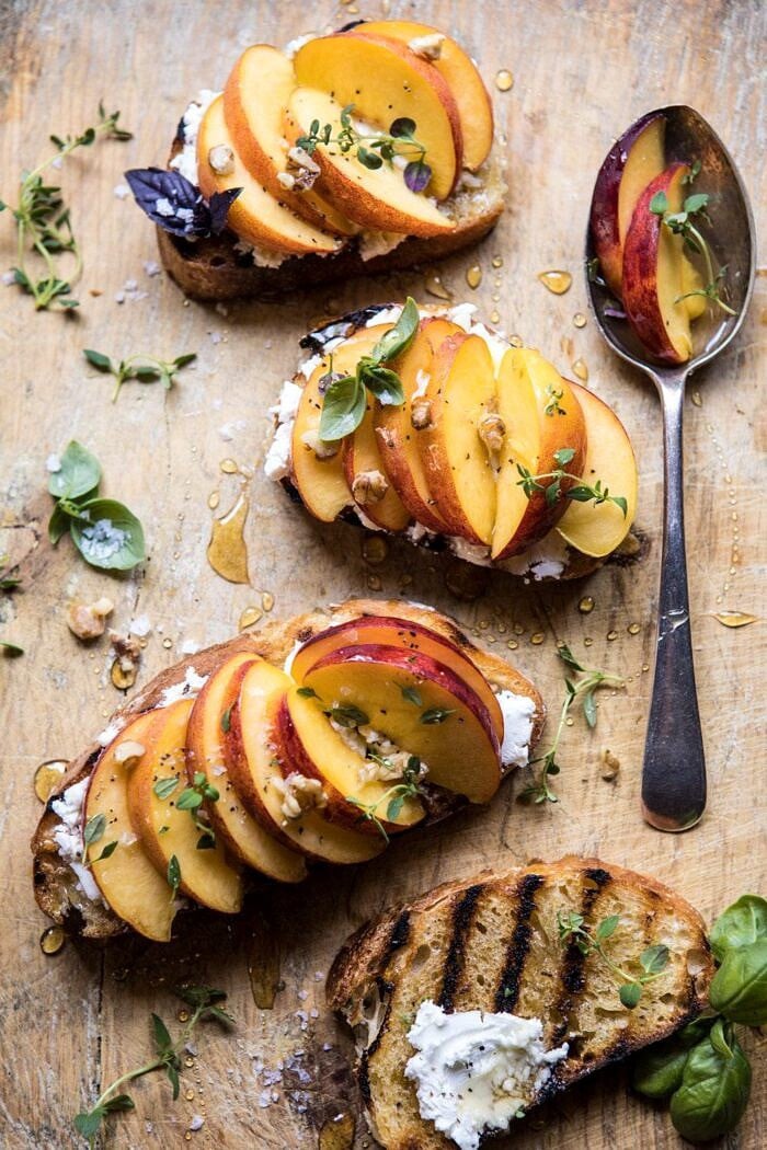 Thyme, Honey, Peach, and Goat Cheese Crostini | halfbakedharvest.com #peaches #summerrecipes #appetizers #easy overhead photo of Thyme, Honey, Peach, and Goat Cheese Crostini with spoon