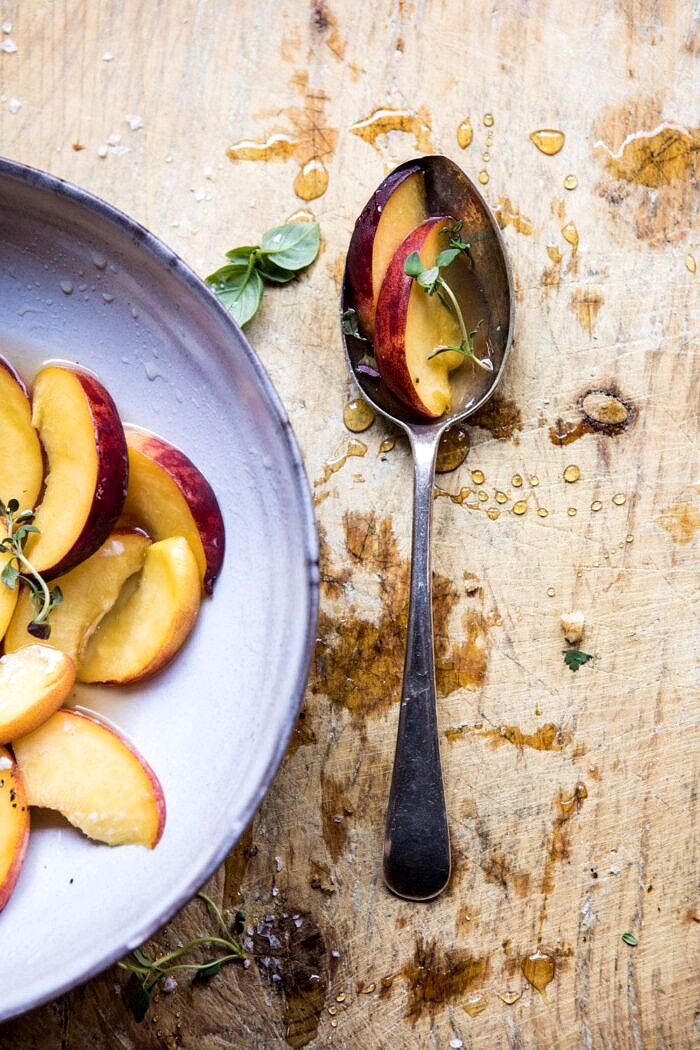 Thyme, Honey, Peach, and Goat Cheese Crostini | halfbakedharvest.com #peaches #summerrecipes #appetizers #easy overhead photo of sliced peaches with honey