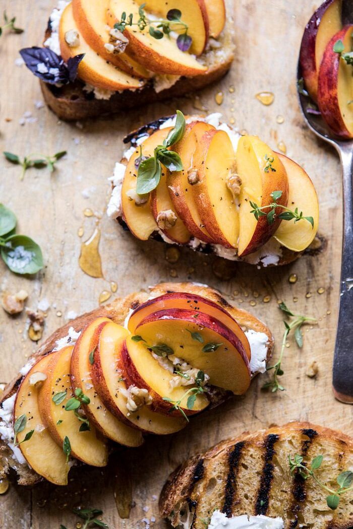 Thyme, Honey, Peach, and Goat Cheese Crostini | halfbakedharvest.com #peaches #summerrecipes #appetizers #easy overhead close up photo of Thyme, Honey, Peach, and Goat Cheese Crostini