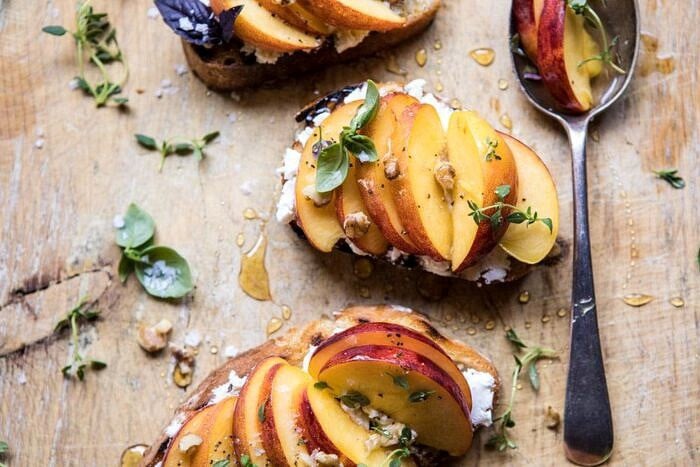 Thyme, Honey, Peach, and Goat Cheese Crostini | halfbakedharvest.com #peaches #summerrecipes #appetizers #easy horizontal overhead photo of Thyme, Honey, Peach, and Goat Cheese Crostini