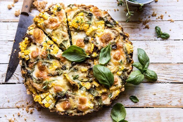 Cheesy Zucchini and Corn Pie | halfbakedharvest.com #zucchini #corn #summerrecipes #eggs #brie overhead horizontal photo of Cheesy Zucchini and Corn Pie
