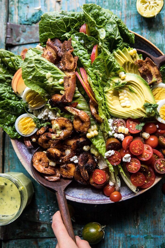 Chipotle Shrimp Cobb Salad with Jalapeno Corn Vinaigrette | halfbakedharvest.com #shrimp #salad #summerrecipes #mexican overhead photo of Chipotle Shrimp Cobb Salad with Jalapeno Corn Vinaigrette with salad tongs