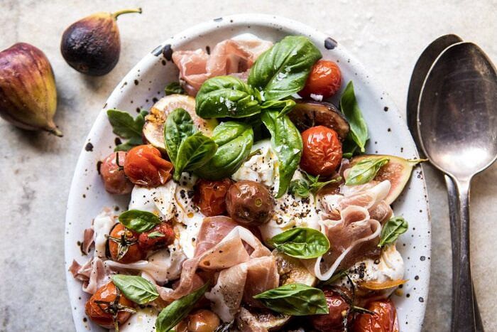 Fresh Fig, Prosciutto, and Arugula Salad with Cherry Tomato Vinaigrette | halfbakedharvest.com #summer #salad #tomatoes #burrata horizontal photo of Fresh Fig, Prosciutto, and Arugula Salad with Cherry Tomato Vinaigrette
