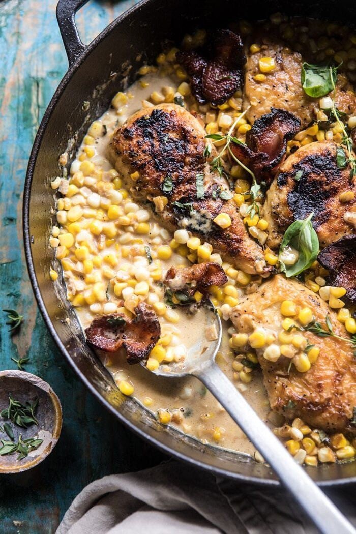 Garlic Butter Creamed Corn Chicken | halfbakedharvest.com #chicken #corn #summer #easy #dinner Garlic Butter Creamed Corn Chicken with spoon and extra sauce