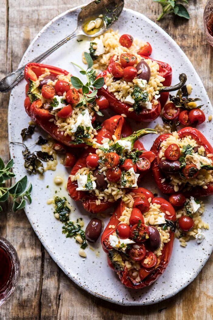 overhead close up photo of Greek Orzo Stuffed Red Peppers with Lemony Basil Tomatoes