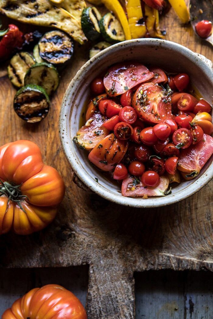 Marinated Tomato and Grilled Veggie Cheese Board | halfbakedharvest.com #cheeseboard #summerrecipes #easy #4thofjulyrecipe close up photo of Marinated Tomatoes