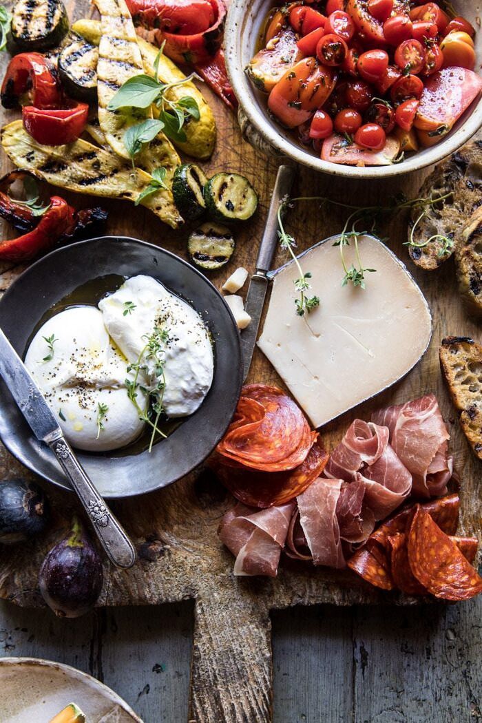 Marinated Tomato and Grilled Veggie Cheese Board | halfbakedharvest.com #cheeseboard #summerrecipes #easy #4thofjulyrecipe close up overhead photo of Marinated Tomato and Grilled Veggie Cheese Board