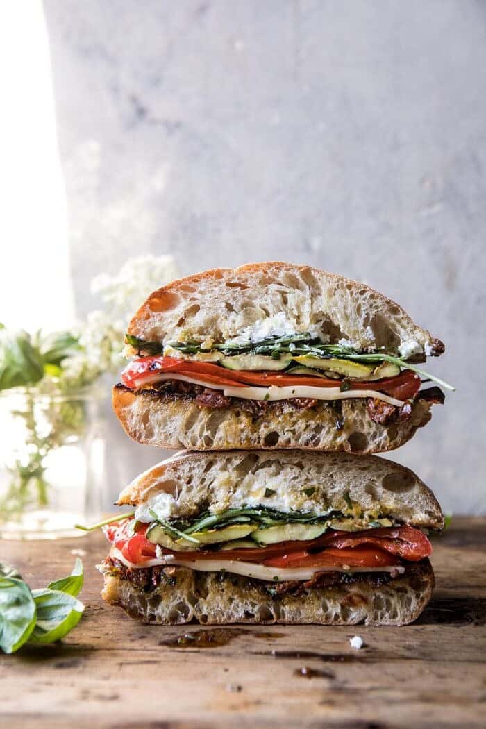 Marinated Veggie Cheese Sandwich with Sun-Dried Tomato Pesto | halfbakedharvest.com #easyrecipe #summer #sandwhich #healthyrecipes #dinner #easy #lunch front on photo of two Marinated Veggie Cheese Sandwiches with Sun-Dried Tomato Pesto stacked on top of each other