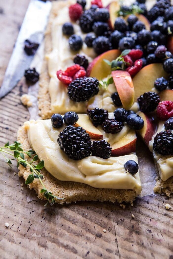 No Bake Mixed Berry Custard Tart | halfbakedharvest.com #summerrecipes #easyrecipes #nobake #fruit side angle photo of No Bake Mixed Berry Custard Tart square