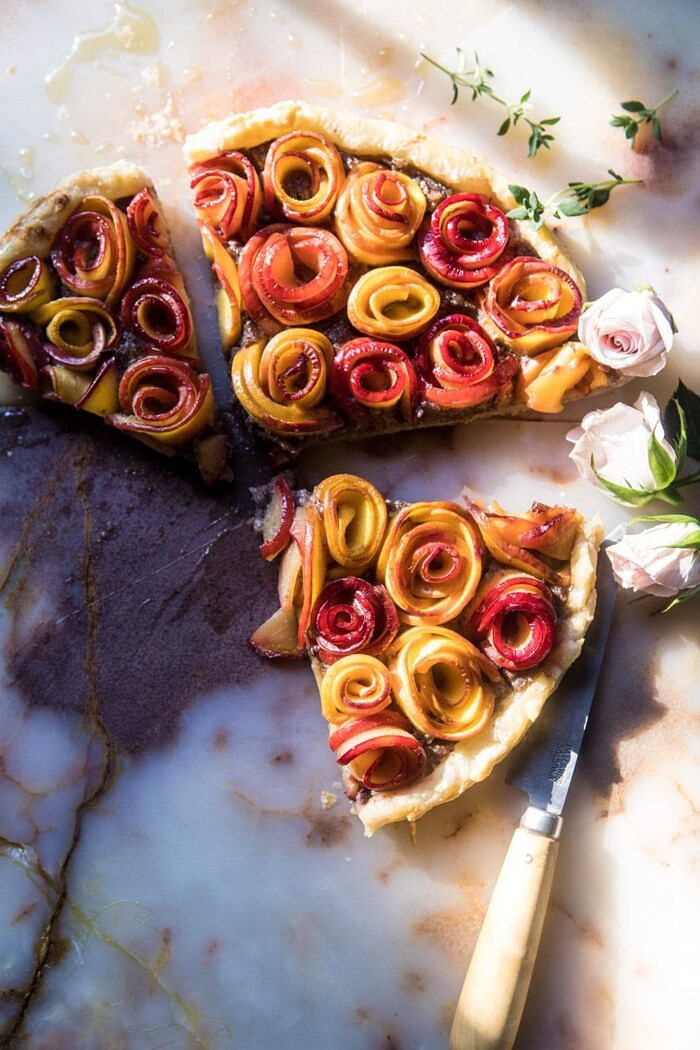 Sweet Peach Rose Tart | halfbakedharvest.com #peach #summerrecipes #tart #summer #pie overhead photo of Sweet Peach Rose Tart cut into 3 triangles with sun streaking through