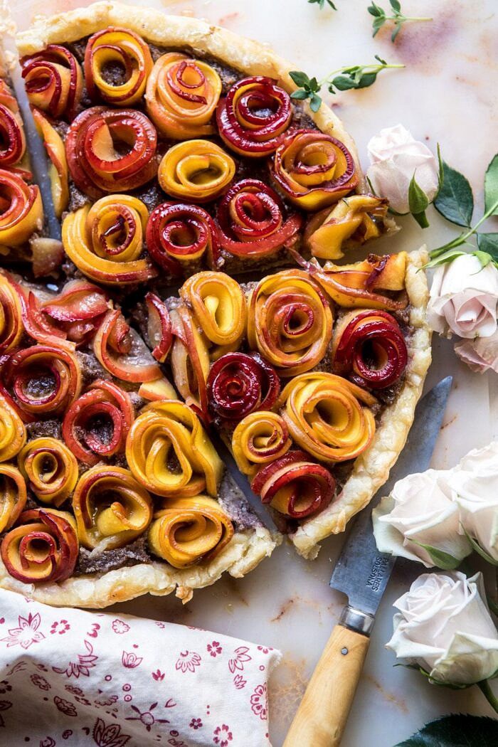 Sweet Peach Rose Tart | halfbakedharvest.com #peach #summerrecipes #tart #summer #pie overhead photo of Sweet Peach Rose Tart with 4 pieces cut into triangles