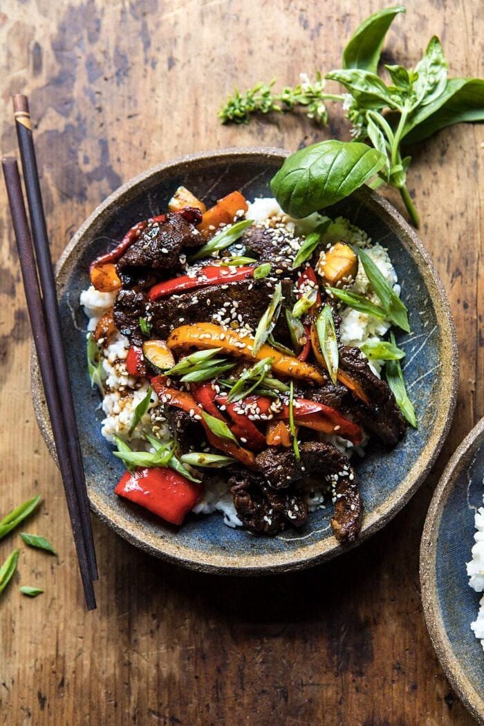 30 Minute Korean Beef and Peppers with Sesame Rice | halfbakedharvest.com #quick #easy #familydinner #korean #steak overhead photo of 30 Minute Korean Beef and Peppers with Sesame Rice and chopsticks on side of bowl