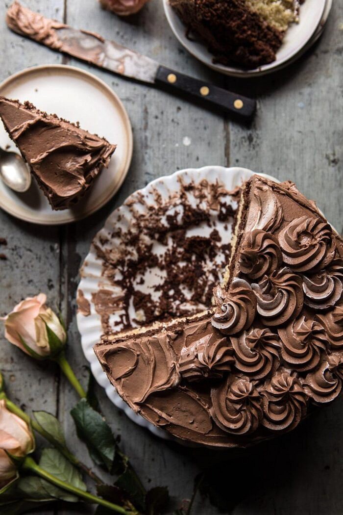 Better Together Chocolate Vanilla Birthday Cake | halfbakedharvest.com #chocolate #cake #birthdaycake #dessert overhead photo of Better Together Chocolate Vanilla Birthday Cake with cake slices missing