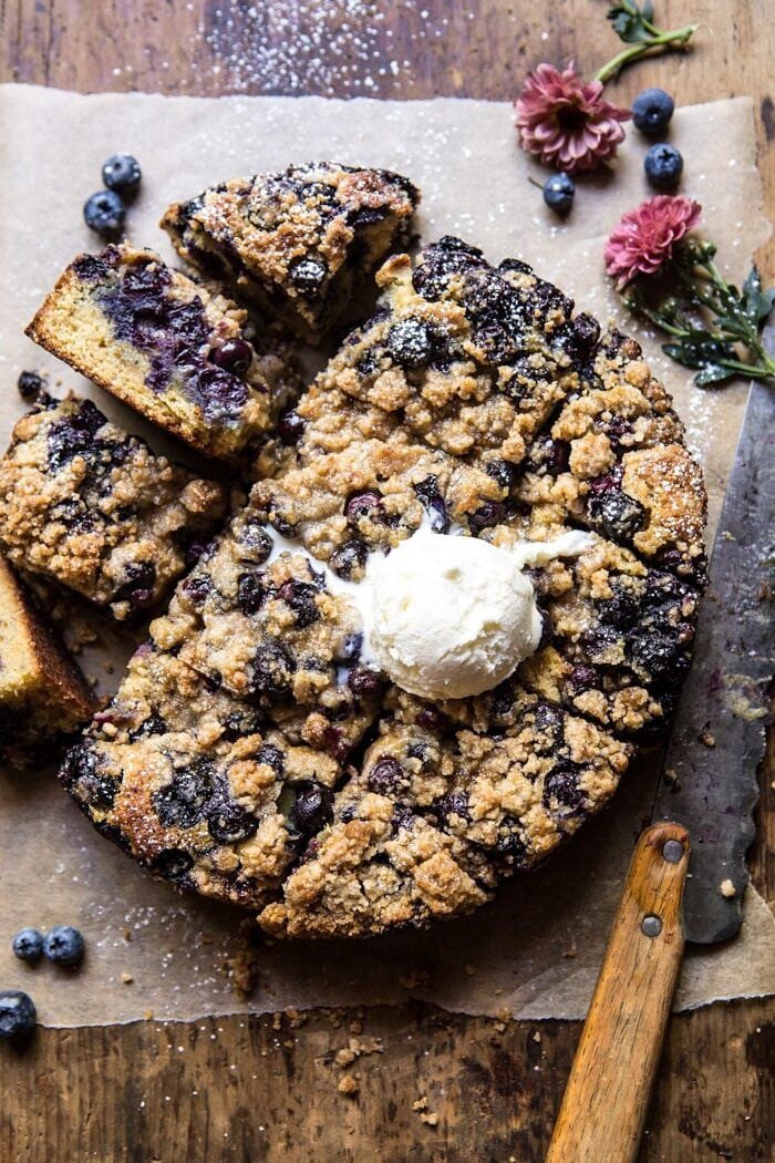 overhead photo of Bursting Blueberry Cardamom Buckle with ice cream scoop on top