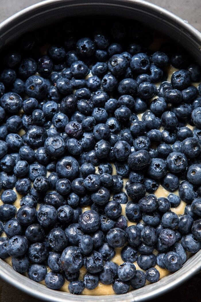 overhead photo of blueberries on top of buckle batter before baking