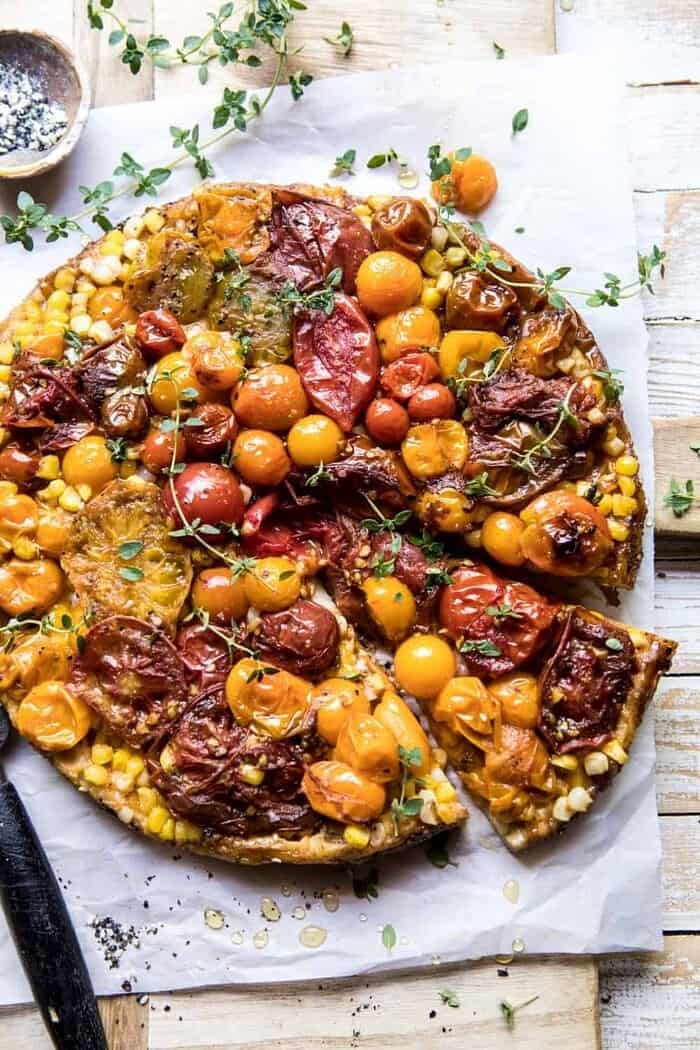 Caramelized Corn and Tomato Tarte Tatin | halfbakedharvest.com #simple #east #tomatoes #summer #tomatotart overhead photo of Caramelized Corn and Tomato Tarte Tatin with slice cut