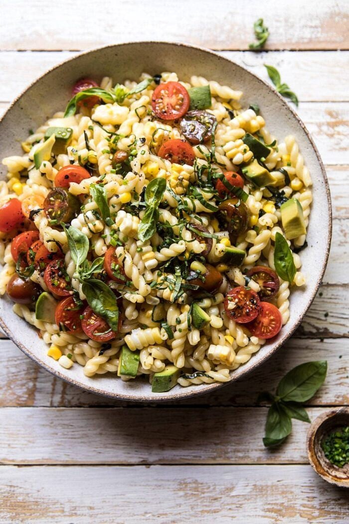 Corn, Tomato, and Avocado Pasta Salad | halfbakedharvest.com #pasta #summer #pastasalad #easy overhead photo of Corn, Tomato, and Avocado Pasta Salad