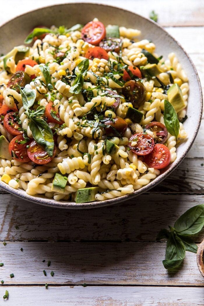 Corn, Tomato, and Avocado Pasta Salad | halfbakedharvest.com #pasta #summer #pastasalad #easy side angled photo of Corn, Tomato, and Avocado Pasta Salad