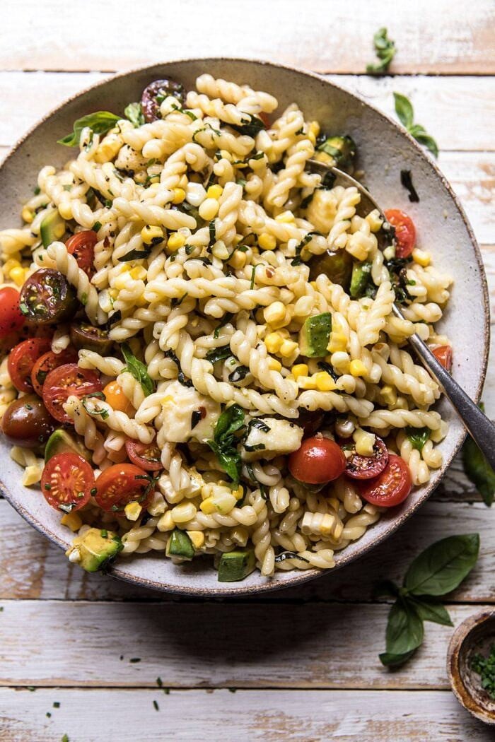 Corn, Tomato, and Avocado Pasta Salad | halfbakedharvest.com #pasta #summer #pastasalad #easy overhead photo of Corn, Tomato, and Avocado Pasta Salad