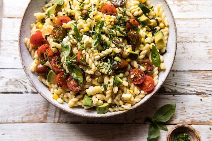 Corn, Tomato, and Avocado Pasta Salad | halfbakedharvest.com #pasta #summer #pastasalad #easy horizontal overhead photo of Corn, Tomato, and Avocado Pasta Salad