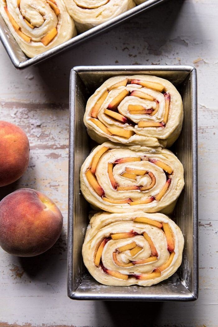 overhead photo of Flaky Pull Apart Cinnamon Peach Brioche Bread before baking in bread pan