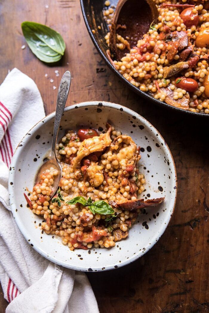One Pot Tomato Basil Lobster and Herbed Pearl Couscous | halfbakedharvest.com #lobster #tomatoes #easyrecipes #summerrecipes #onepot One Pot Tomato Basil Lobster and Herbed Pearl Couscous in single serve bowl with spoon