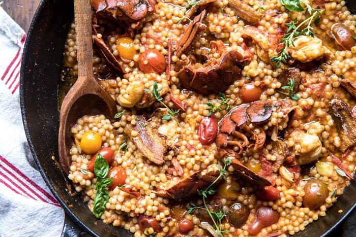 One Pot Tomato Basil Lobster and Herbed Pearl Couscous | halfbakedharvest.com #lobster #tomatoes #easyrecipes #summerrecipes #onepot overhead horizontal photo of One Pot Tomato Basil Lobster and Herbed Pearl Couscous