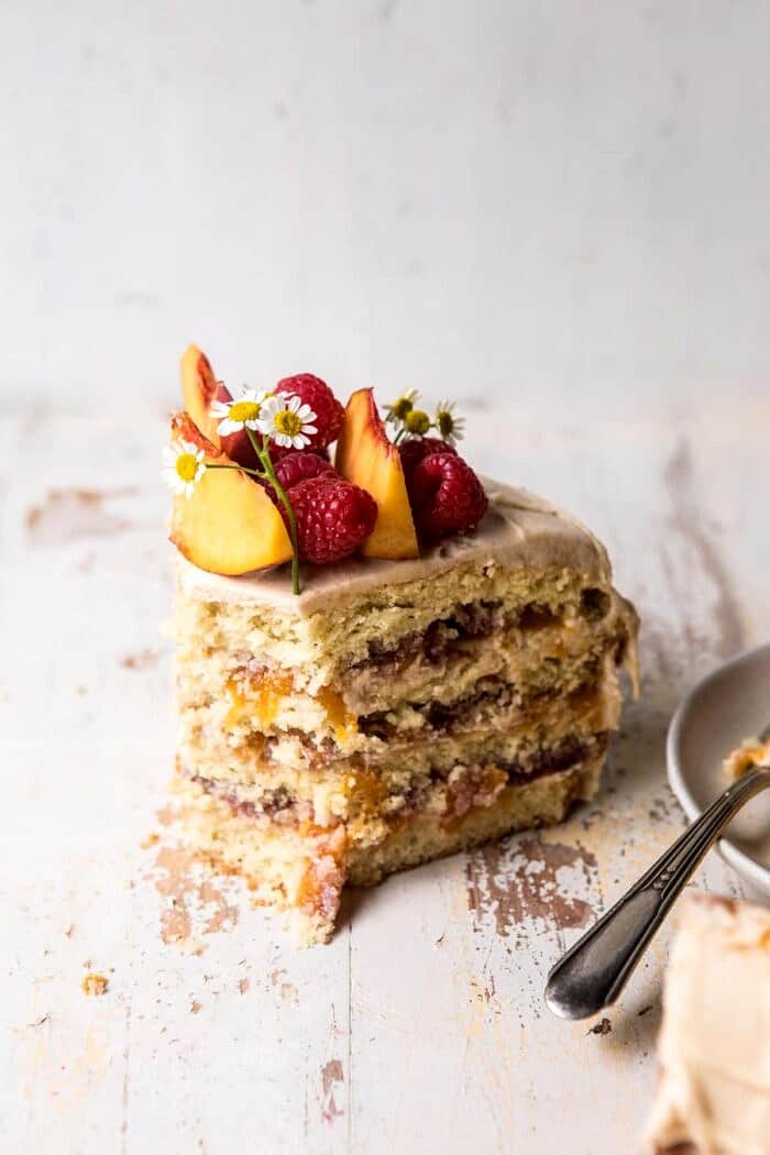 Peach Ricotta Layer Cake with Browned Butter Buttercream with bites removed from cake slice