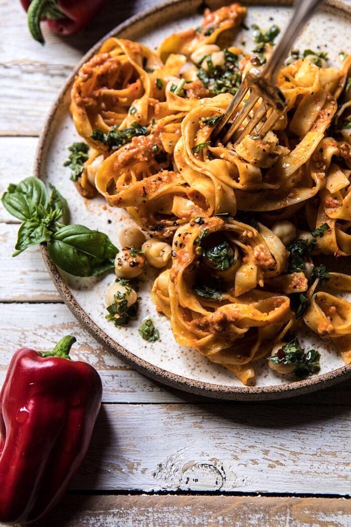 side angle photo of Roasted Red Pepper Pasta with White Beans and Basil wth fork in pasta