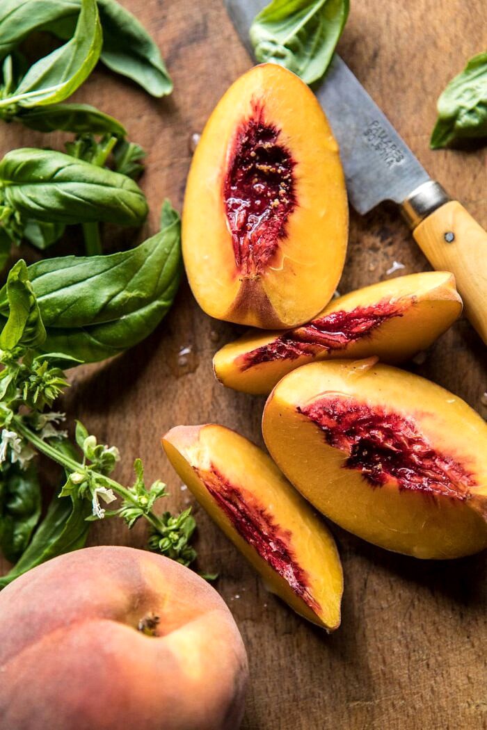 Rosemary Chicken, Caramelized Corn, and Peach Salad with Hot Bacon Vinaigrette | halfbakedharvest.com #salad #chicken #easyrecipes #summer #corn overhead photo of raw peaches