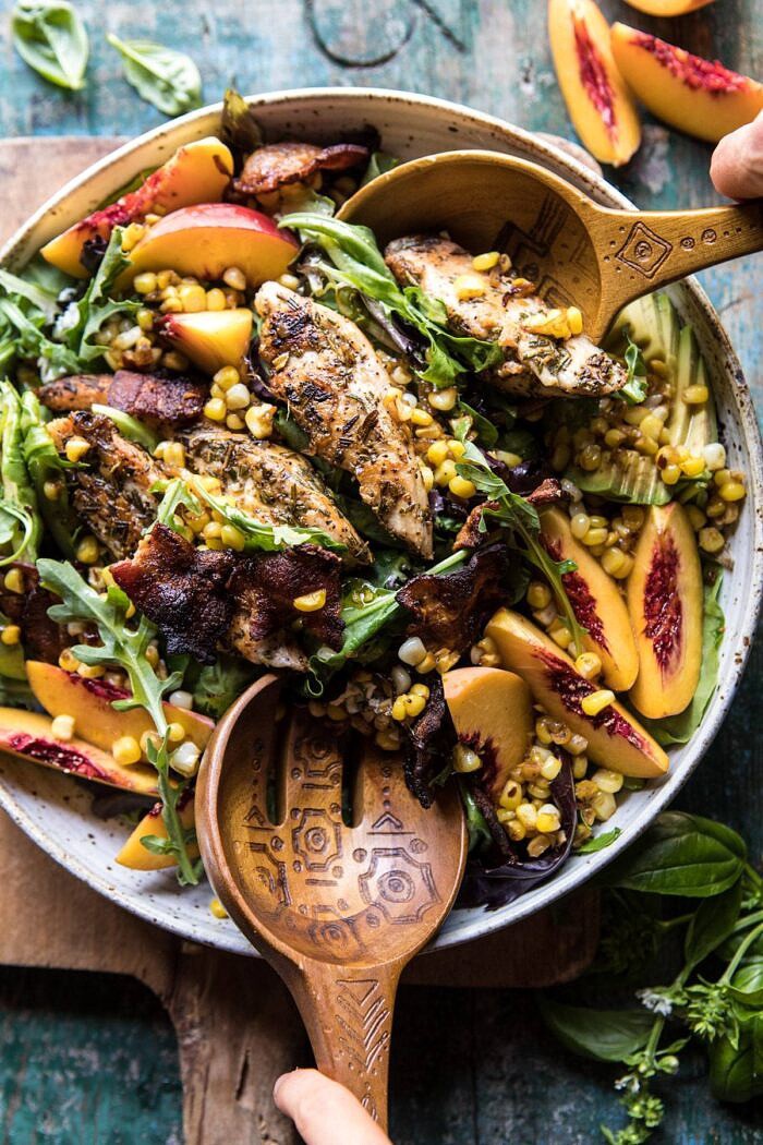 Rosemary Chicken, Caramelized Corn, and Peach Salad with Hot Bacon Vinaigrette | halfbakedharvest.com #salad #chicken #easyrecipes #summer #corn tossing the Rosemary Chicken, Caramelized Corn, and Peach Salad with salad spoons