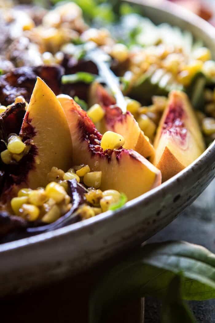 Rosemary Chicken, Caramelized Corn, and Peach Salad with Hot Bacon Vinaigrette | halfbakedharvest.com #salad #chicken #easyrecipes #summer #corn close up side angle photo of Rosemary Chicken, Caramelized Corn, and Peach Salad with Hot Bacon Vinaigrette