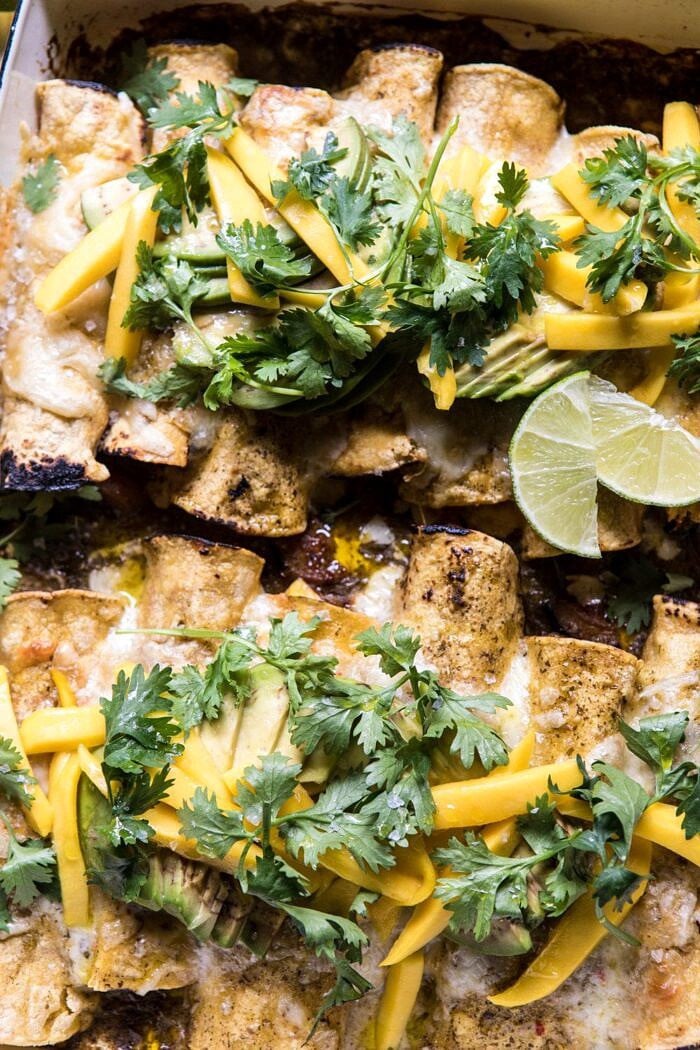 Salsa Verde Chicken and Zucchini Enchiladas with Mango | halfbakedharvest.com #mexican #enchiladas #zucchini #summerrecipes #easy overhead close up photo of Salsa Verde Chicken and Zucchini Enchiladas with Mango