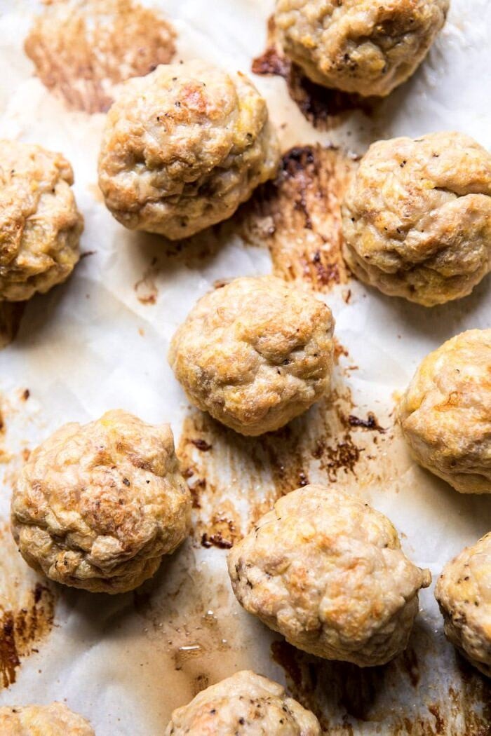 30 Minute Butter Chicken Meatballs | halfbakedharvest.com #meatballs #easyrecipes #Indianrecipes #curry #butterchicken 30 Minute Butter Chicken Meatballs on baking sheet